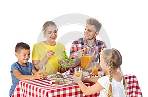 Happy family having picnic at table on  background