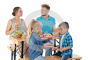 Happy family having picnic at table on white