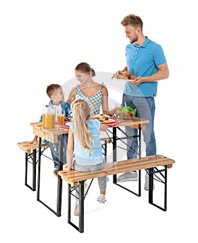 Happy family having picnic at table on white