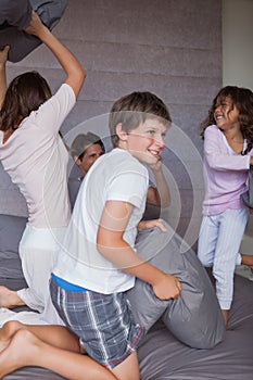 Happy family having a pillow fight on the bed