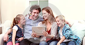 Happy family having video call with tablet