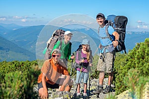 Happy family hiking in the mountains