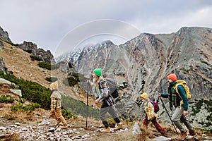 Happy family hiking together in autumn mountains.