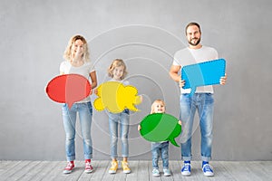 Happy family holding colorful paper speech bubble blank