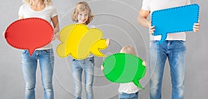 Happy family holding colorful paper speech bubble blank