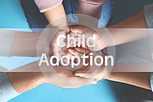 Happy family holding hands on background, top view. Child adoption concept