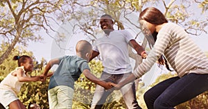 Happy family holding hands and falling