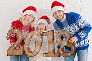 Happy family holding numbers 2018
