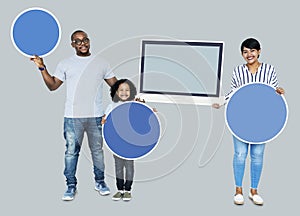 Happy family holding round boards and a screen