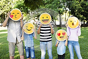 Happy family holding up emojis
