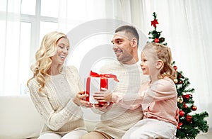 Happy family at home with christmas gift box