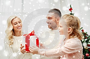 Happy family at home with christmas gift box