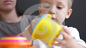 happy family at home. mom and son play toy. happy family together kid dream concept. baby son play collects toy fun
