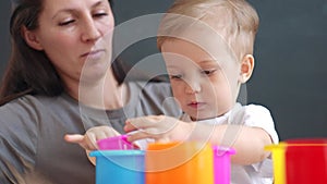 happy family at home. mom and son play toy. happy family together kid dream concept. baby son play collects toy pyramids