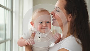 Happy family at home. Mother holding little toddler child daughter. Mom and baby girl relax playing having fun together