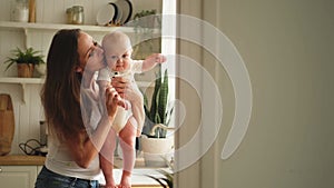 Happy family at home. Mother holding little toddler child daughter. Mom and baby girl relax playing having fun together