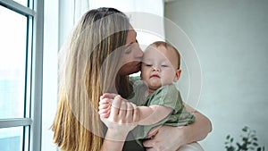 Happy family at home. Mother holding little toddler child daughter. Mom and baby girl relax playing having fun together