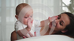 Happy family at home. Mother with little toddler child daughter. Mom and newborn baby girl relax playing having fun