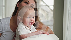 Happy family at home. Mother with little toddler child daughter. Mom and newborn baby girl relax playing having fun