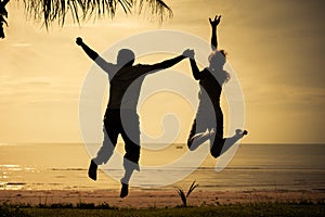 Happy family jumping on the beach