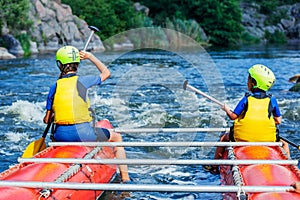 Happy family kayaking on the river on a sunny day during summer vacation