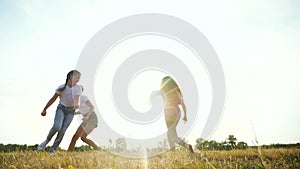 Happy family kid together run catch-up in the park at silhouette. people in the park concept. mom daughter and joyful