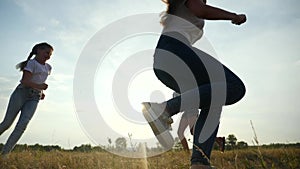 happy family kid together run catch-up in the park at silhouette. people in the park concept. mom daughter and joyful