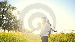 happy family kids. people in the park children child running together in the park at sunset silhouette. mom dad daughter