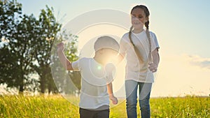 happy family kids. people in the park children child running together in the park at sunset silhouette. mom dad daughter