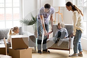 Happy family with kids playing on moving day at home