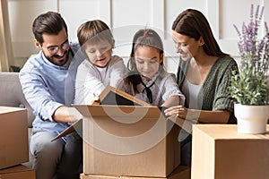 Happy family with kids unpack on relocation day
