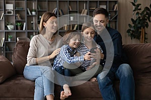 Happy family with kids use cellphone at home