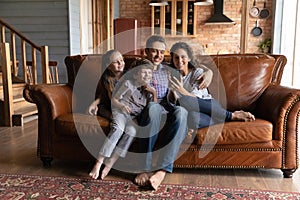 Happy family with kids use modern cellphone at home