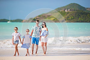 Happy family with kids walk on the beach