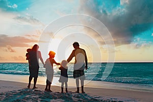 happy family with kids walk at sunset beach