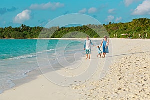 happy family with kids walk on tropical beach