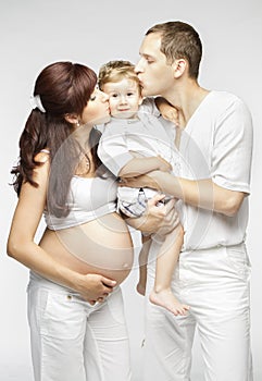 Happy Family Kiss Child, Pregnant Mother Father Kissing Kid Boy