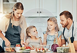 Happy family in kitchen, cooking together with children and teaching, learning and nutrition with parents. Mom, dad and
