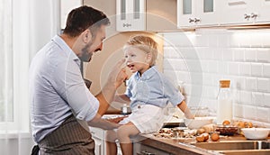 Happy family in kitchen. father and child baking cookies