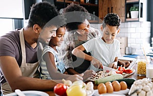 Happy family in the kitchen having fun and cooking together. Healthy food at home.