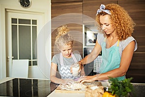 Happy family in the kitchen. mother and child daughter cooking together.