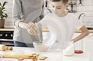 Happy Family In Kitchen. Mother And Child Preparing Dough