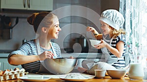 Happy family in kitchen. mother and child preparing dough, bake