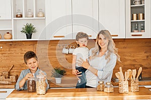 Happy family in the kitchen. mother and children preparing the dough, bake cookies photo