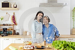 Happy family in the kitchen. Mother and her adult daughter are preparing proper meal. mother and daughter