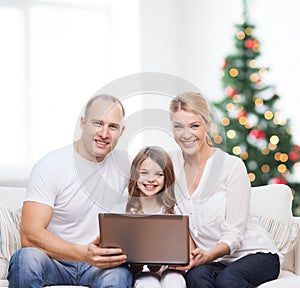 Happy family with laptop computer