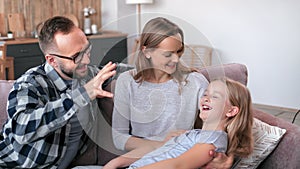 Happy family laughing positive emotion spending time at comfortable home together having weekend