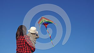 happy family launches a kite. happy childhood kid dream concept. mother and son playing with a kite in the park. family