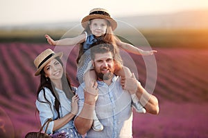 Happy family in laveder field. mother, father and child in sunset light in blooming lavender