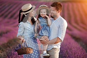 Happy family in laveder field. mother, father and child in sunset light in blooming lavender